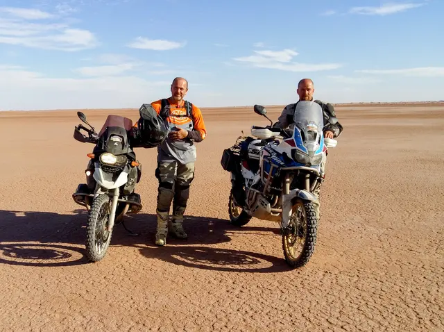 Morocco autumn tour: two men with motorcycles in the desert